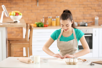 Obraz na płótnie Canvas Beautiful woman preparing bakery in kitchen at home
