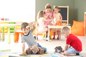 Cute little children playing in kindergarten