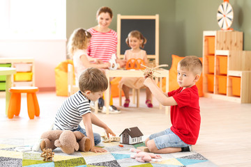 Cute little children playing in kindergarten