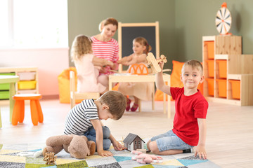 Cute little children playing in kindergarten