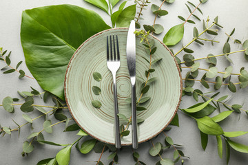 Simple table setting with tropical leaves