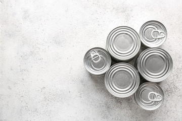 Tin cans with food on grey background