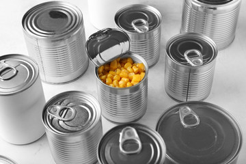 Tin cans with food on light background