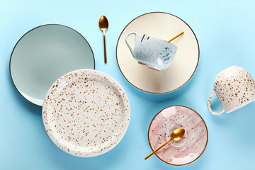 Different tableware on color background