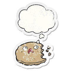 cartoon cookie and thought bubble as a distressed worn sticker