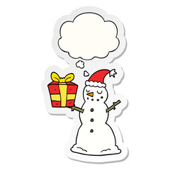 cartoon snowman with present and thought bubble as a printed sticker