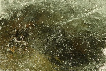 Close-up of bubbly, refreshing, clear Lake Fork Creek in Beartooth Mountains, Montana