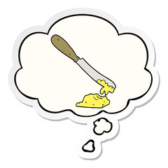 cartoon knife spreading butter and thought bubble as a printed sticker
