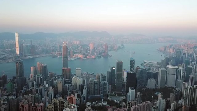 Aerial: Hong Kong Cityscape with Victoria Harbor Between Skyscrapers
