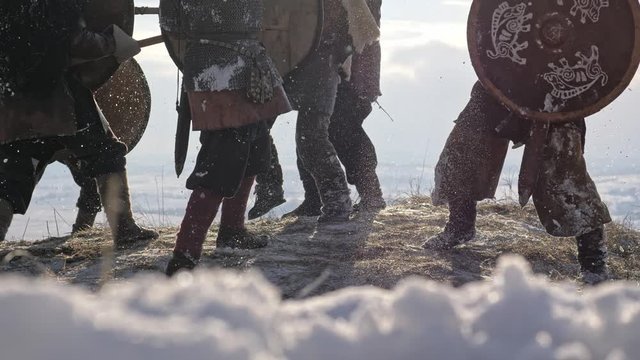 Warriors of vikings are fighting during attack at winter time.