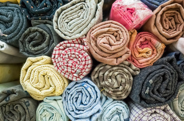 background of colorful fabric stacks