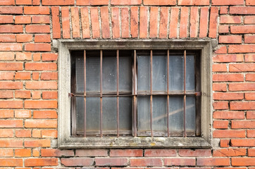 Fototapeta na wymiar old window on red brick wall