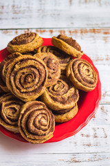 Cinnamon roll or cinnamon bun - sweet baked dessert with spices, flour, sugar and butter.