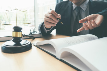 Judge gavel with Justice lawyers having team meeting at law firm background. Concepts of Law and...