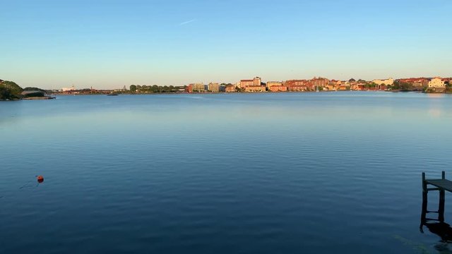 Looking out over the beautiful naval city of Karlskrona, Sweden with a little bridge in the water, showing the fortress Goodnight and the cityscape standing right next to the ocean