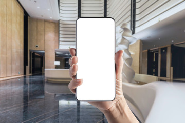 Hand-held mobile phone in hotel lobby