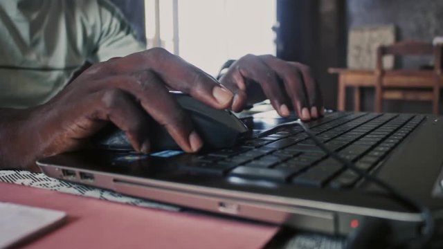 Man siting in sitting room with Laptop Working on Archicad at Cotonou Benin Africa