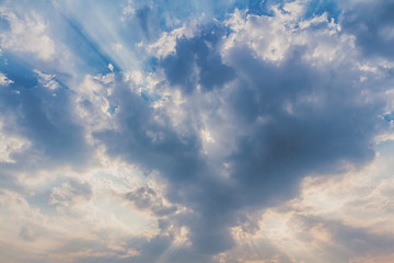 Besutiful ray of sunlight breaking through clouds at sunset.