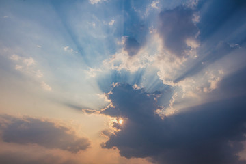 Besutiful ray of sunlight breaking through clouds at sunset.