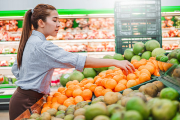 Asian women shopping Healthy food vegetables and fruits in supermarket