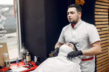 Man with a beard. Hairdresser with a client.