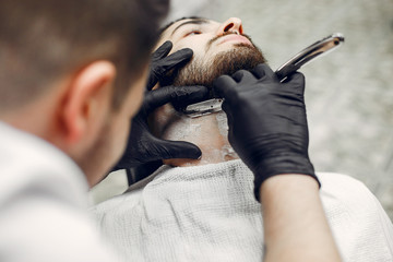 Man with a beard. Hairdresser with a client.