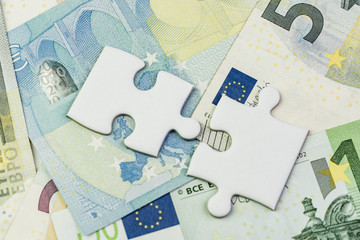 Direction of Europe and UK after brexit negotiation concept, jigsaw puzzle on Euro banknotes with Euro flag and map of Europe and United Kingdom island