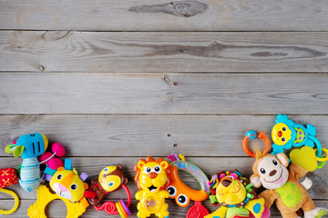 Set of toys for newborn on wooden background. top view