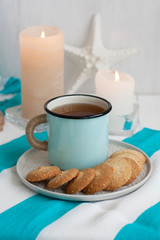 Obraz na płótnie Canvas A study break: a mug of tea with cookies on a side.