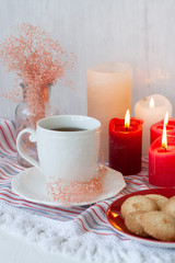 Obraz na płótnie Canvas A tasty treat: a cup of tea with cookies on a side.