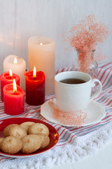A tasty treat: a cup of tea with cookies on a side.
