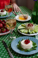 A gourmet dinner for two: grilled camembert, white wine and various appetizers.