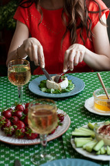 A gourmet dinner for two: grilled camembert, white wine and various appetizers.