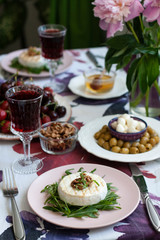 A gourmet dinner for two: grilled camembert, red wine and various appetizers.