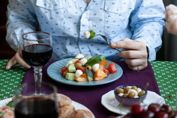 A gourmet lunch for two: a salad, fresh cherries and various appetizers.