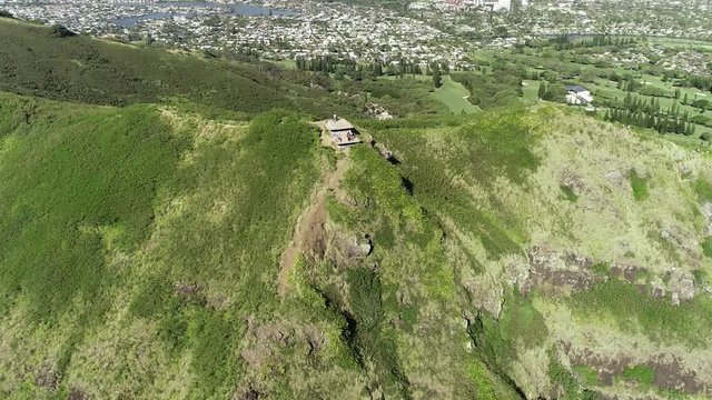 Aerial view of Lanikai beach, Honolulu, Hawaii, low angle view with drone camera moving backwards, people taking pictures on pill box world war II monument