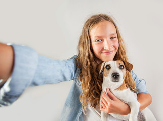 Smiling teen making selfie photo on smartphone over white background  cute girl