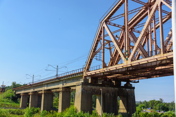 passenger train is traveling along the railway bridge over the river.