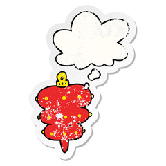 cartoon christmas decoration and thought bubble as a distressed worn sticker