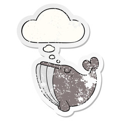 cartoon whale and thought bubble as a distressed worn sticker