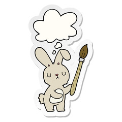 cartoon rabbit with paint brush and thought bubble as a printed sticker