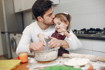 Family in a kitchen. Handsome father with litle daughter