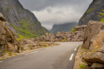 Asphalt road in the foggy mountains of Norway in the spring