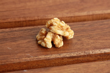 Peeled walnuts on wooden background