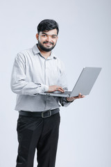 Young Indian / Asian man showing laptop screen