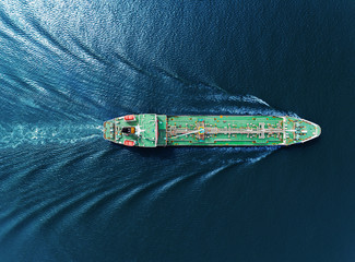 Aerial top view Oil ship tanker full speed transportation oil from refinery on the sea.