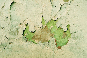 Grunge old painted wall of the house close up green color toned. Abstract background