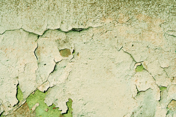 Grunge old painted wall of the house close up green color toned. Abstract background