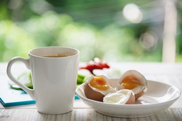 Boiled eggs with fresh cucumber salad and coffee cup breakfast set - top view breakfast food concept