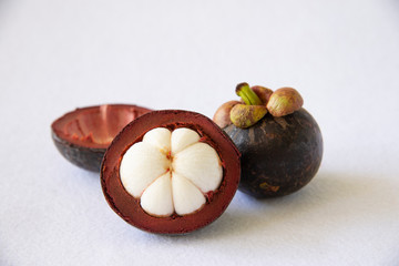 Mangosteen Thai popular fruits - a tropical fruit with sweet juicy white segments of flesh inside a thick reddish-brown rind.